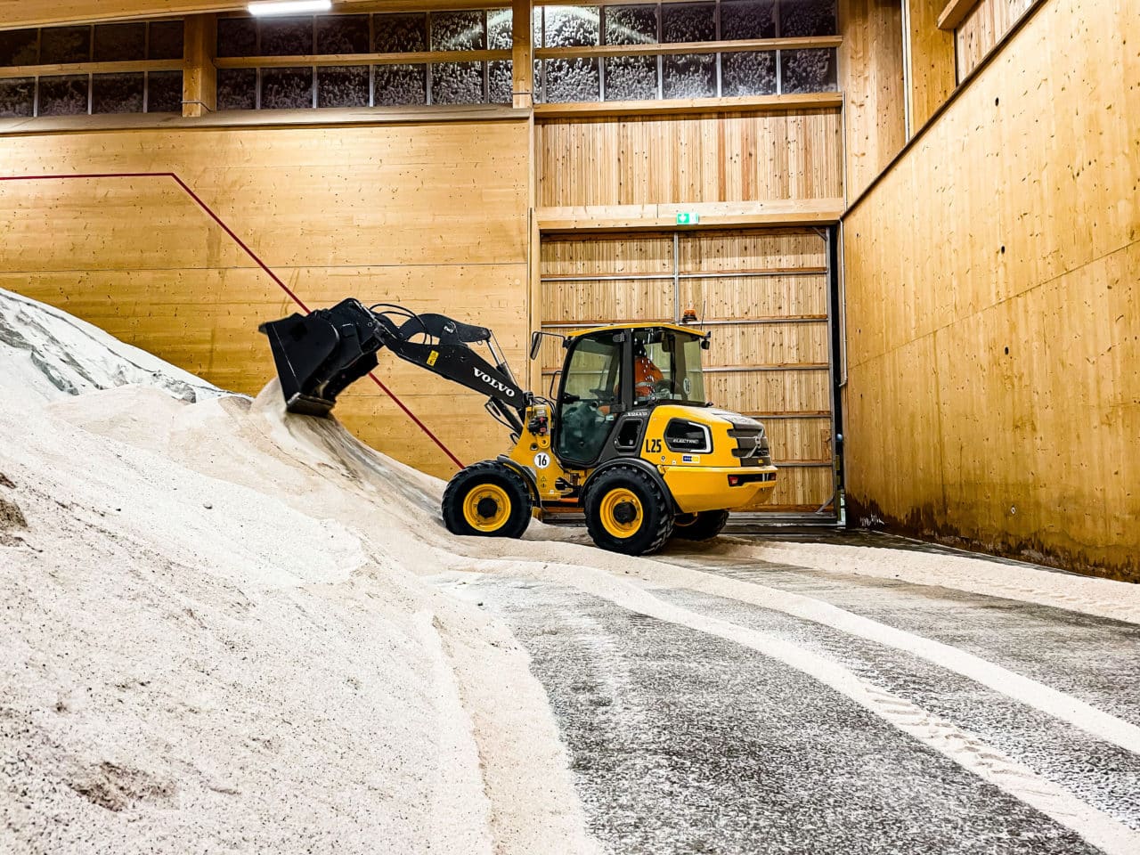 a volvo loader depositing a load in a warehouse