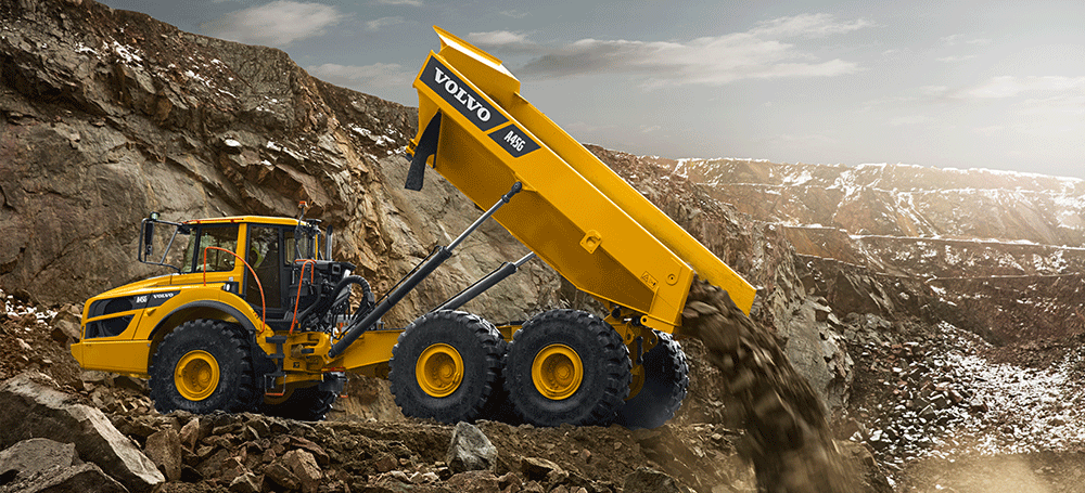 articulated truck dumping load at a jobsite