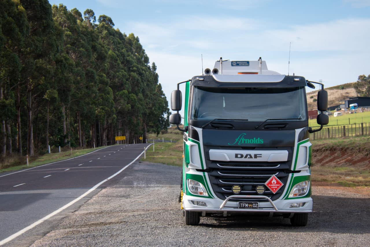 a daf vehicle parked on some gravel on the side of a road